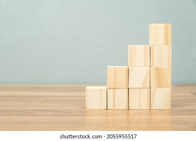 Growth step stairs arranged by wood cubes on the table, business growth and success concept