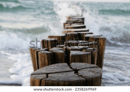 groynes jutting into the baltic sea. clouds shrouded with warm light atmosphere. Coastal landscape