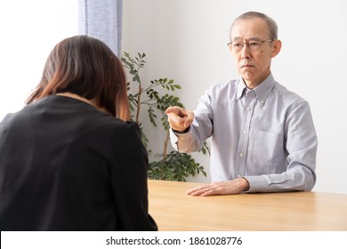 Grumpy Senior Asian Man Talking In Living Room