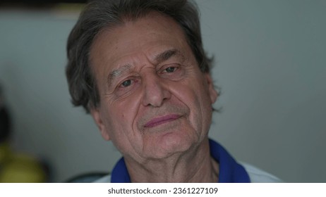 Grumpy senior man close-up face looking at camera with upset pensive expression - Powered by Shutterstock