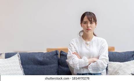 Grumpy Young Asian Woman Sitting Sofa