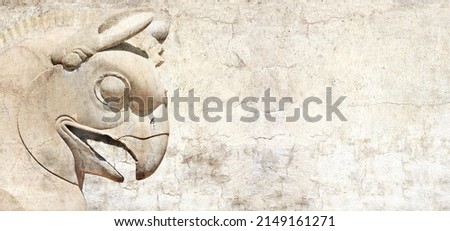 Grunge background with stone texture and bas-relief of head of griffin. Horizontal banner with ancient griffin statue in Persepolis, Iran. Copy space for text. Mock up template 