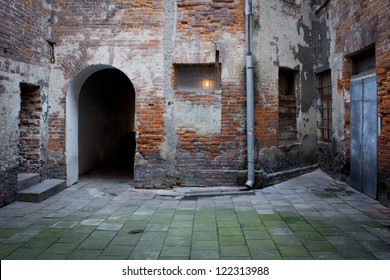 Grunge dark alley, slums of the city, squalid dirty corner of street in the decadent old town