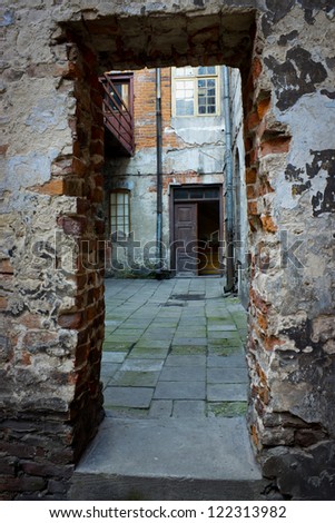 Grunge dark alley, slums of the city, squalid dirty corner of street in the decadent old town