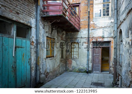 Grunge dark alley, slums of the city, squalid dirty corner of street in the decadent old town