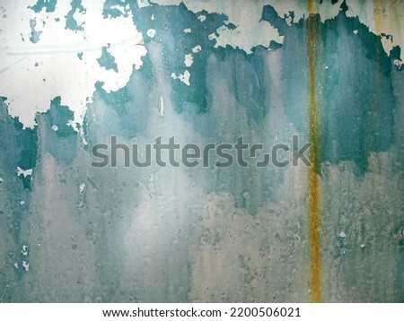 grunge green steel door with dirty mud stains, weathered metal plate with peeling color coat surface and flow traces of rust, abstract texture background