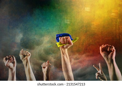 Grunge image of fists, one holding a blue and yellow flag, concept of Ukrainian resistance  - Shutterstock ID 2131547213