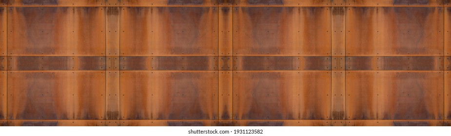 Grunge orange brown rusty corten steel facade wall with rivets, rust metal texture background banner panorama