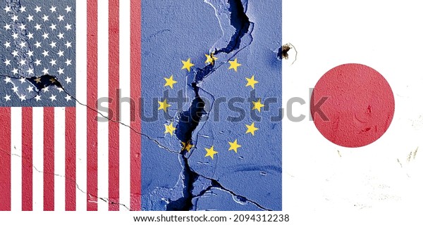Grunge pattern of US EU\
Japan vertical national flags isolated on rough broken concrete\
wall with cracks background, abstract international countries\
contrast power concept
