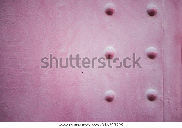 Grunge steam punk background metal\
plate with screws. Metal old pink steam punk background.\
