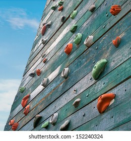 Grunge Surface Of An Artificial Rock Climbing Wall With Toe And Hand Hold Studs.