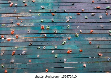 Grunge Surface Of An Artificial Rock Climbing Wall With Toe And Hand Hold Studs.