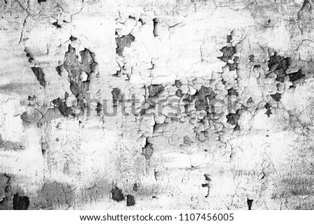 Grunge white metal wall with peeling paint, close-up background photo texture