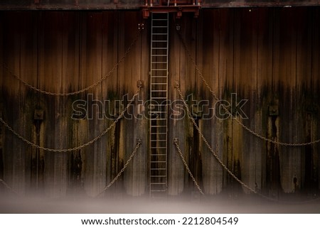 Grungey Chains and Ladder on side of dock