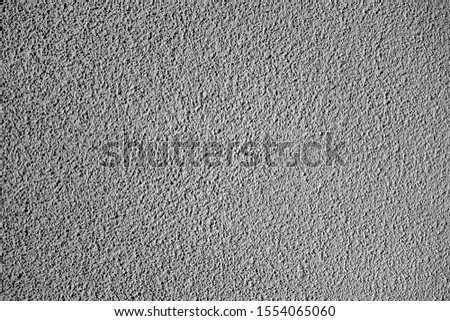 Grungy cement wall texture in black and white. Abstract background and pattern for design.