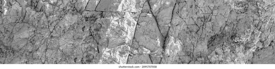 Grungy cragged bumpy pitted cavity stone facade, split layer gap.Ruined cracked shattered worn rough hiking canyon.Old ragged grunge steep marble cliff. Grand vintage crannied damaged impressive gorge - Powered by Shutterstock