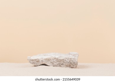 Grungy grey concrete stone platform podium for cosmetics or products on white beach sand background. Front view - Shutterstock ID 2155649039