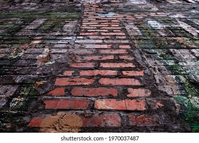 Grungy Old Brick Wall With Flaking And Peeling Paint From Low Perspective Looking Up