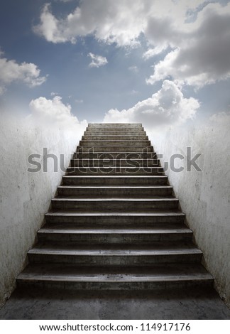 A grungy old concrete staircase going up into a blue cloudy sky.