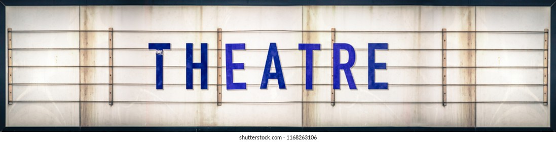 A Grungy Old Weathered Theatre Marquee Sign With Blue Letters