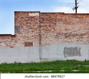 Grungy red brick wall of an old abandoned warehouse in downtown Denver Colorado.
