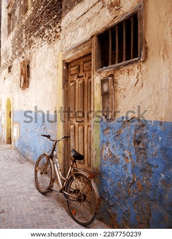 Grungy, rusty old bike in alleyway, Essaouira, Morocco