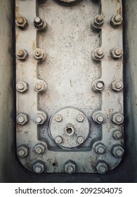 A Grungy Rusty Steel Hatch Door Secured With Nuts And Bolts.