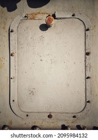 A Grungy Rusty Steel Hatch Door Secured With Nuts And Bolts.