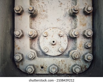 A Grungy Rusty Steel Hatch Door Secured With Nuts And Bolts.