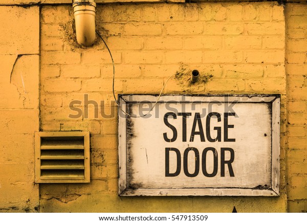 Grungy Stage Door Sign\
Outside A Theatre