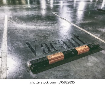 Grungy Vacant Parking Spot With A Blended Overlaid Text