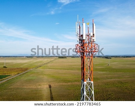 GSM and radio telecommunication tower. Cell phone tower, aerial drone view. Base transceiver station. Wireless communication antenna transmitter.  
