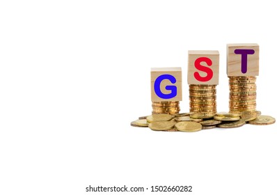 GST Or TAX Concept With Colorful Wooden Block And Stacked Coins On White Background