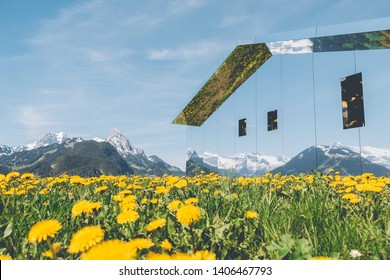 GSTAAD - MAY 23, 2019: The Swiss Alps Reflected On Mirage Gstaad By Doug Aitken