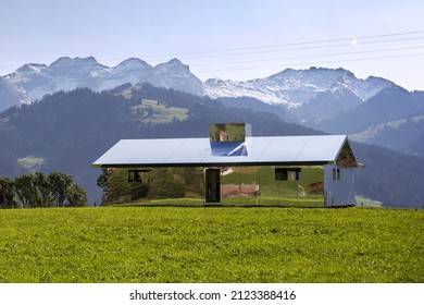 Gstaad, Switzerland - September 30, 2020: The Swiss Alps Landscape Reflected On Mirage Gstaad By Doug Aitken