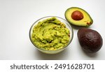 Guacamole or Guac is an avocado based dip, spread, or salad first developed in Mexico. made from avocado aka alligator pear - Persea americana -  isolated on white background