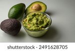 Guacamole or Guac is an avocado based dip, spread, or salad first developed in Mexico. made from avocado aka alligator pear - Persea americana -  isolated on white background