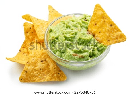 Guacamole sauce and tortilla chips, popular Mexican food  isolated on white background. 