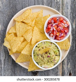 Guacamole, Tomato Salsa And Corn Chips On A Plate, Top View, Closeup