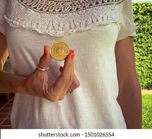 Guadalajara, Jalisco - September 10 2019: Woman Proudly Holds AA Alcoholics Anonymous 10 Month Sobriety Chip In Her Hand, Awarded For Abstaining From Alcohol Or Other Substances. Addiction Recovery 