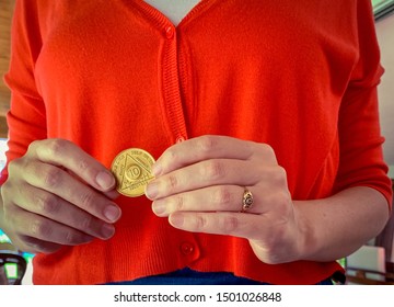 Guadalajara, Jalisco - September 10 2019: Woman Proudly Holds AA Alcoholics Anonymous 10 Month Sobriety Chip In Her Hand, Awarded For Abstaining From Alcohol Or Other Substances. Addiction Recovery 