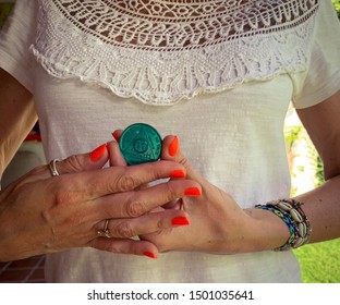 Guadalajara, Jalisco - September 10 2019: Young Adult Woman Proudly Holds AA Alcoholics Anonymous 11 Month Sobriety Chip, Awarded For Abstaining From Alcohol Or Other Substances. Addiction Recover 