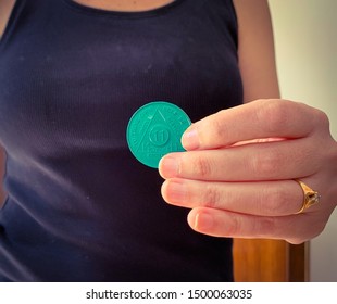 Guadalajara, Jalisco - September 9 2019: Woman Proudly Holds AA Alcoholics Anonymous 11 Months Sobriety Chip In Her Hand, Awarded For Abstaining From Alcohol Or Other Substances. Addiction Recovery