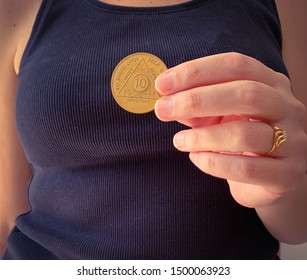 Guadalajara, Jalisco - September 9 2019: Woman Proudly Holds AA Alcoholics Anonymous 10 Months Sobriety Chip In Her Hand, Awarded For Abstaining From Alcohol Or Other Substances. Addiction Recovery