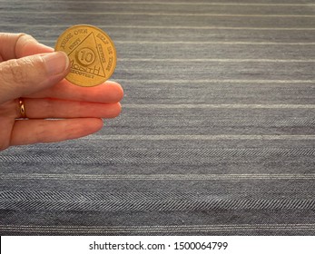 Guadalajara, Jalisco - September 9 2019: Female Hand Holds AA Alcoholics Anonymous 10 Months Sobriety Chip, Awarded For Abstaining From Alcohol Or Other Substances. Addiction Recovery Hope Success 