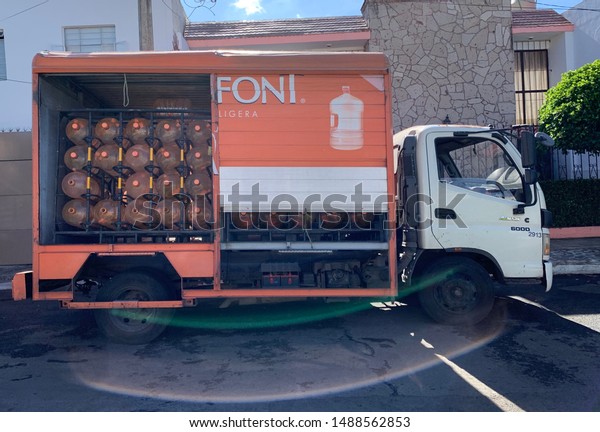 Guadalajara, Mexico; August\
23 2019: Bonafont truck delivering water jugs at home in the\
morning hours\
