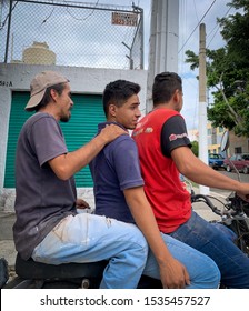 Guadalajara, Mexico - October 19 2019:  Three Men Riding On A Motorcycle On A Sunny Afternoon. Three People Sharing A Motorcycle Bike