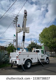 Guadalajara, Mexico - October 22 2019: Electrical Post Fire Incident. Electrical Company Worker On Crane Truck Bucket Attend To An Electrical Post Fire Incident. Electrical Maintenance