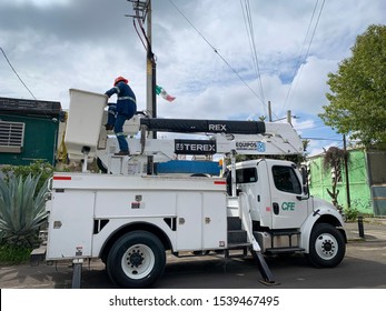 Guadalajara, Mexico - October 22 2019: Electrical Post Fire Incident. Electrical Company Worker On Crane Truck Bucket Attend To Electrical Post Fire Incident. Electrical Maintenance Vehicle CFE Logo