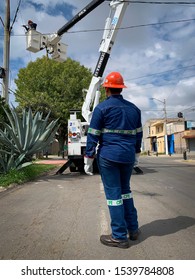 Guadalajara, Mexico - October 22 2019: CFE Male Electrical Company Workers In Uniform Attend To An Electrical Post Fire Incident. Outdoors Street Accident Scene. Blue Collar Workers 